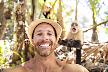 men tourist makes selfie self portrait with monkey © Louis-Paul Photo