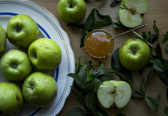  photo of green apples with yellow honey and mint