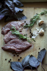 raw meat with basil, herbs and spices