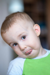 Funny little boy playing fool. Caucasian child 2 years old. Closeup portriat.