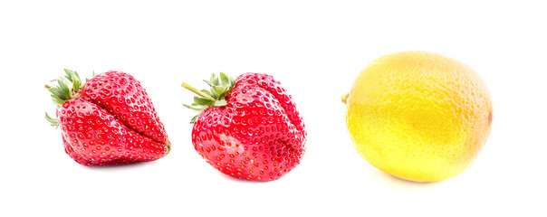 Isolated fruits. lemon and two strawberries isolated on white background