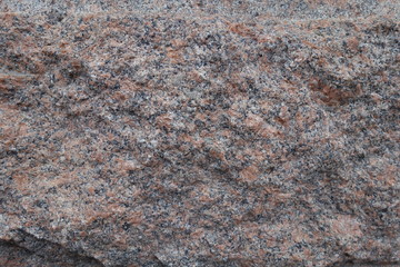 Deliberately rough surface of pink granite stone