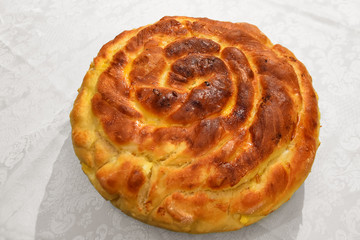 Homemade round bread with cheese and eggs traditionally baked for Sirni Zagovezni celebration in Bulgaria