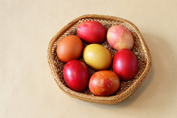 Basket with motley eggs painted in different colors for Easter celebration according to the Eastern Orthodox tradition