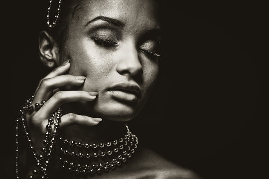 beautiful woman wearing chain jewellery in black and white photo