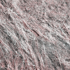 Close up view of transparent ice surface, frozen hay seen through it