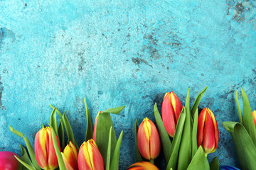 Festive background setting for Easter with eggs and tulips.