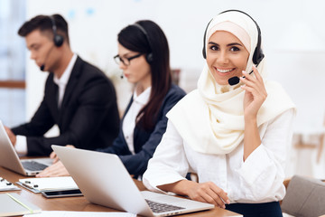 An Arab woman works in a call center.