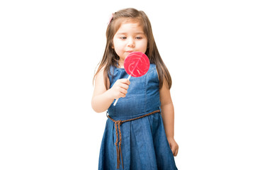 Little girl ready to lick round lollipop