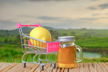 Vinegar and lemon in trolley  on wooden table place