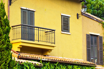 Fototapeta na wymiar Window balcony in the yellow wall