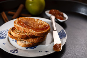 toasts with apple jam on black metallic tray