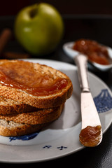 toasts with apple jam on black metallic tray