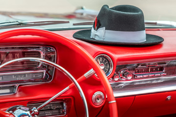 Obraz premium Vintage red dashboard with hat