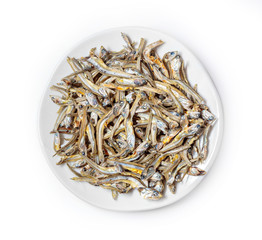Dried sardines used as seasoning in Japanese foods and cooking on white background. Japanese healthy snack food. Niboshi or Iriko fish close up.