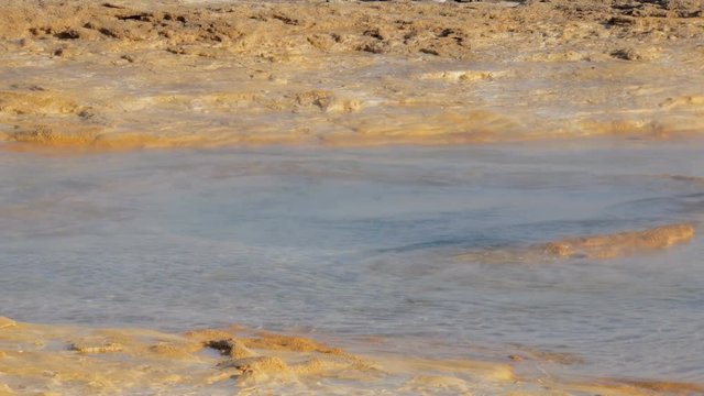 close-up view of starting of eruption of hot spring Strokkur in icelandic valley of geysers