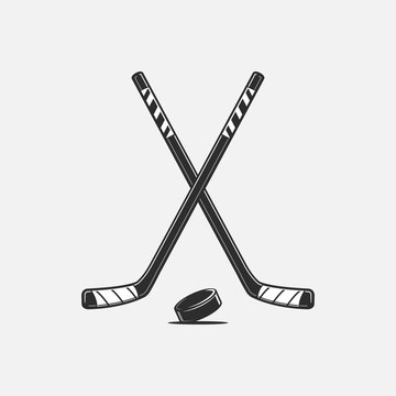Crossed hockey sticks and puck vector illustration