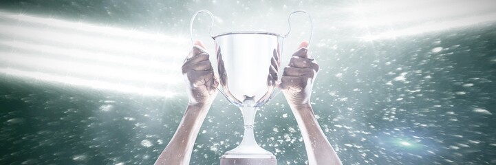 Cropped hand of athlete holding trophy