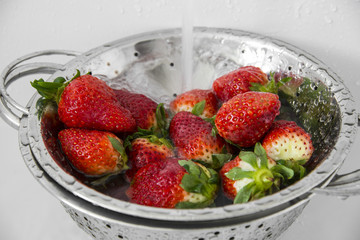 red ripe strawberries close up in a bowl  - washing