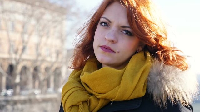 sulky young woman looks at something in the city- slow motion