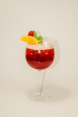 red alcoholic drink with ice on white background