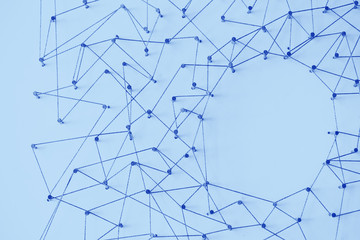 A large grid of pins connected with string. Communication, technology, network concept
