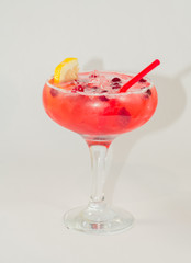 red alcoholic drink with ice on white background