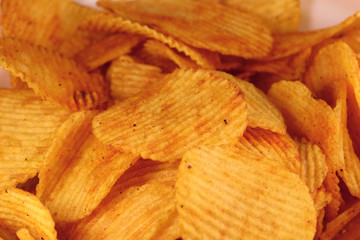 Tasty corrugated potato chips, unhealthy food.