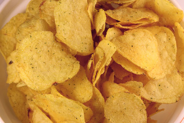 Tasty potato chips, unhealthy food.