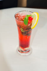 red alcoholic drink with ice on white background