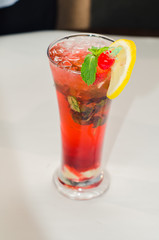 red alcoholic drink with ice on white background
