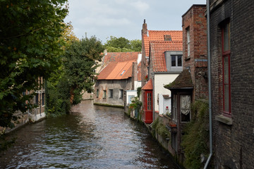 Fototapeta na wymiar European medieval street on the water canal in the town of Bruges