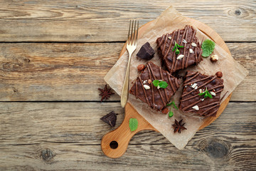 Chocolate brownie cake, dessert with nuts on wooden background.top view