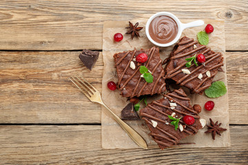 Chocolate brownie cake, dessert with nuts on wooden background.top view