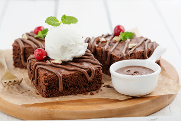 Chocolate brownie cake, dessert with nuts on wooden background.top view