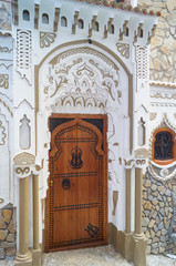 wooden door of white of Morocco House, gate