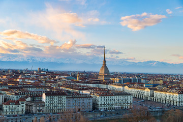 Turin skyline at sunset. Torino, Italy, panorama cityscape with the Mole Antonelliana over the city. Scenic colorful light and dramatic sky.