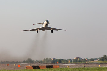 Airplane take off from military airfield. Smoke from engines, low over the runway. Transportation, aviation.