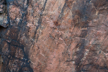 the surface of an old granite stone close up