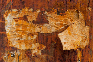 remains of dirty old paper on rusty metal