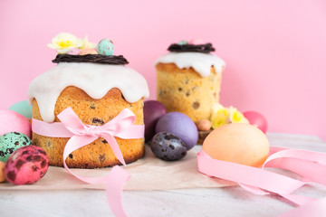 Easter traditional cake with chocolate nest, quail eggs decoration blossom flowers, colorful spring stillife in soft light and trendy pastel colors. Pink backround