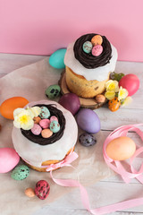 Obraz na płótnie Canvas Easter traditional cake with chocolate nest, candy and quail eggs decoration blossom flowers, colorful spring stillife in soft light and trendy pastel colors. Top view