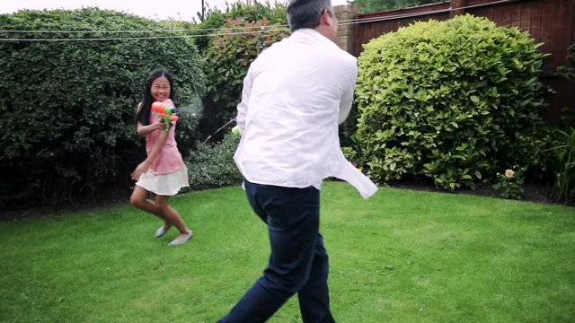 Having a Water Fight with Dad