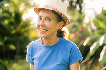 portrait of an older woman outside his house on the warm center equator