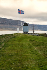 Windmill and Icelandic flag in Vigur island, Iceland