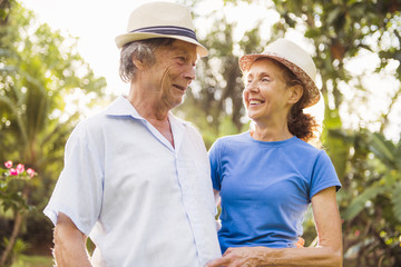 Portrait of a beautiful elderly couple standing embracing outdoors