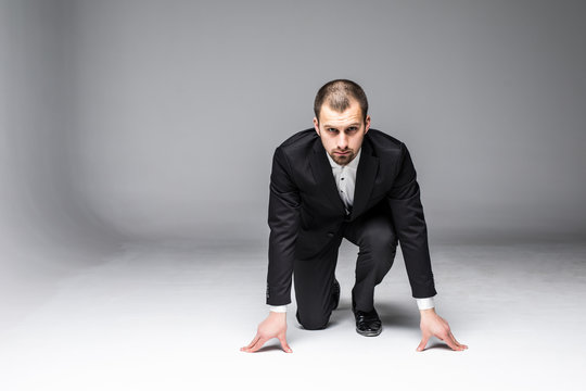 start your business. business man ready to start running over white background