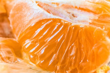 Juicy pulp of orange fruit. Orange slices close-up. Background with limited depth of field.