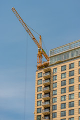 Fototapeta premium new building construction of a modern multi-storey building with a tower crane