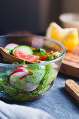 Close-up of summer fresh vegetable salad in kitchen. The concept of the vegetarian and healthy food.